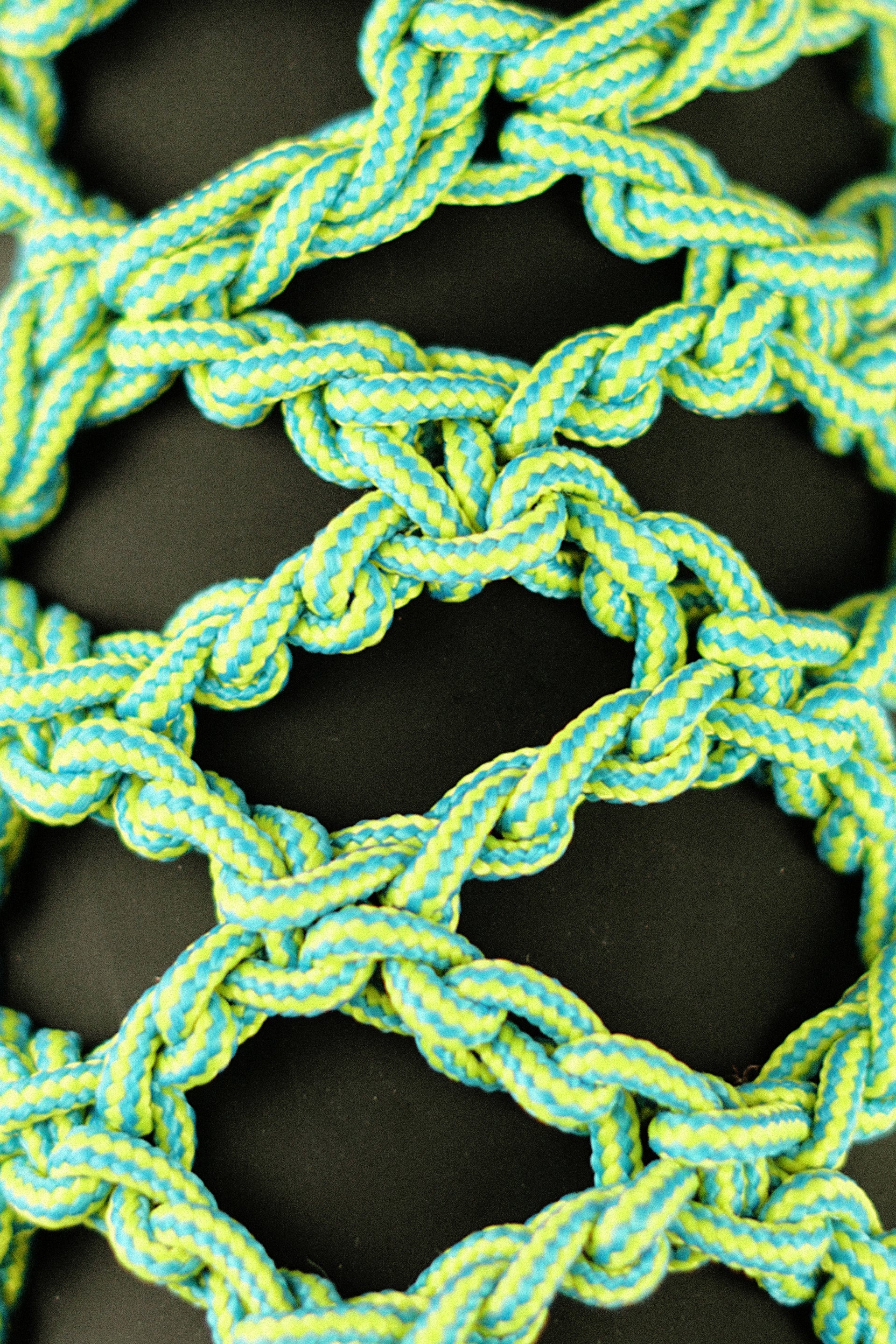 Green and blue bottle porter made of paracord rope
