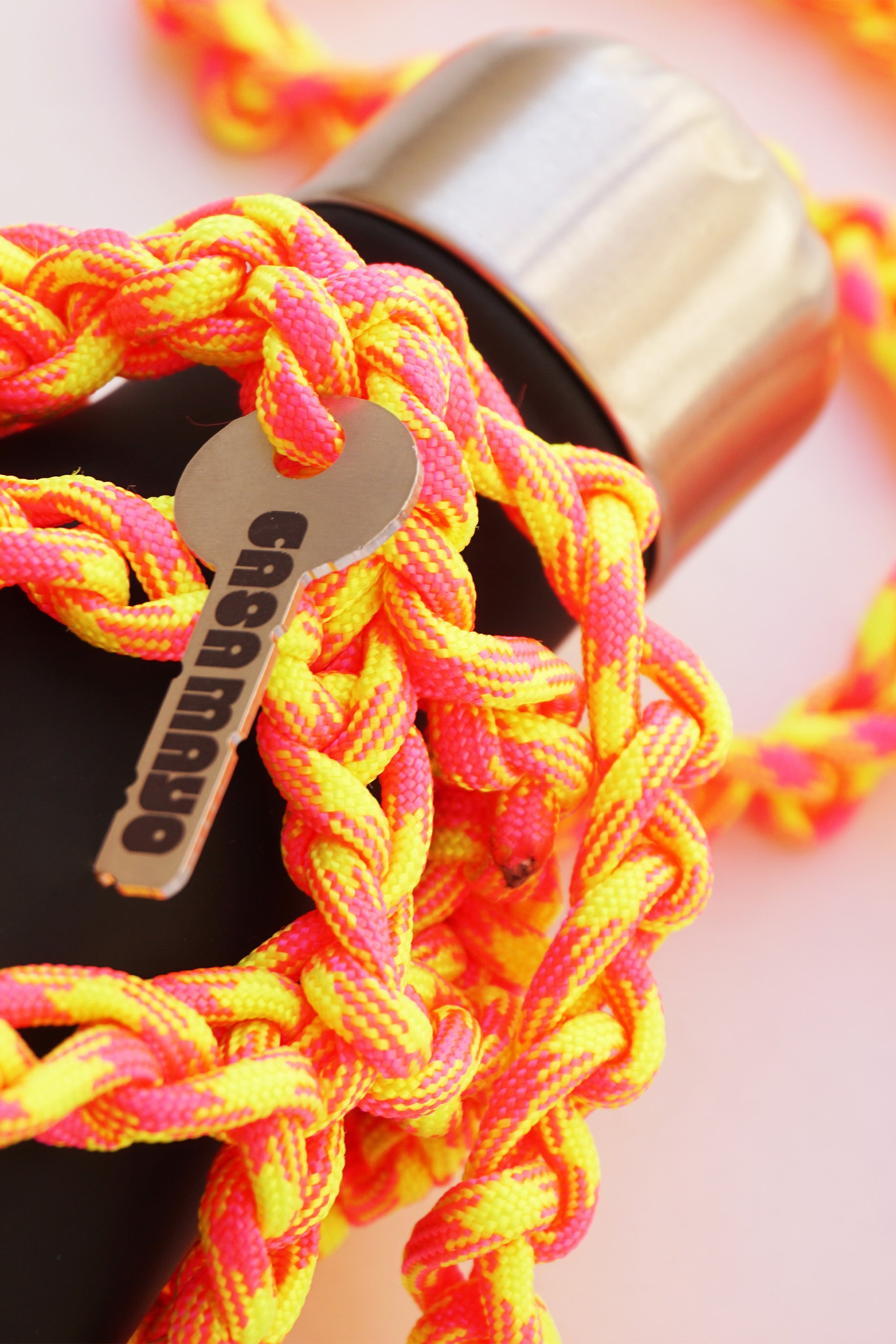 Yellow and pink water porter made of paracord rope