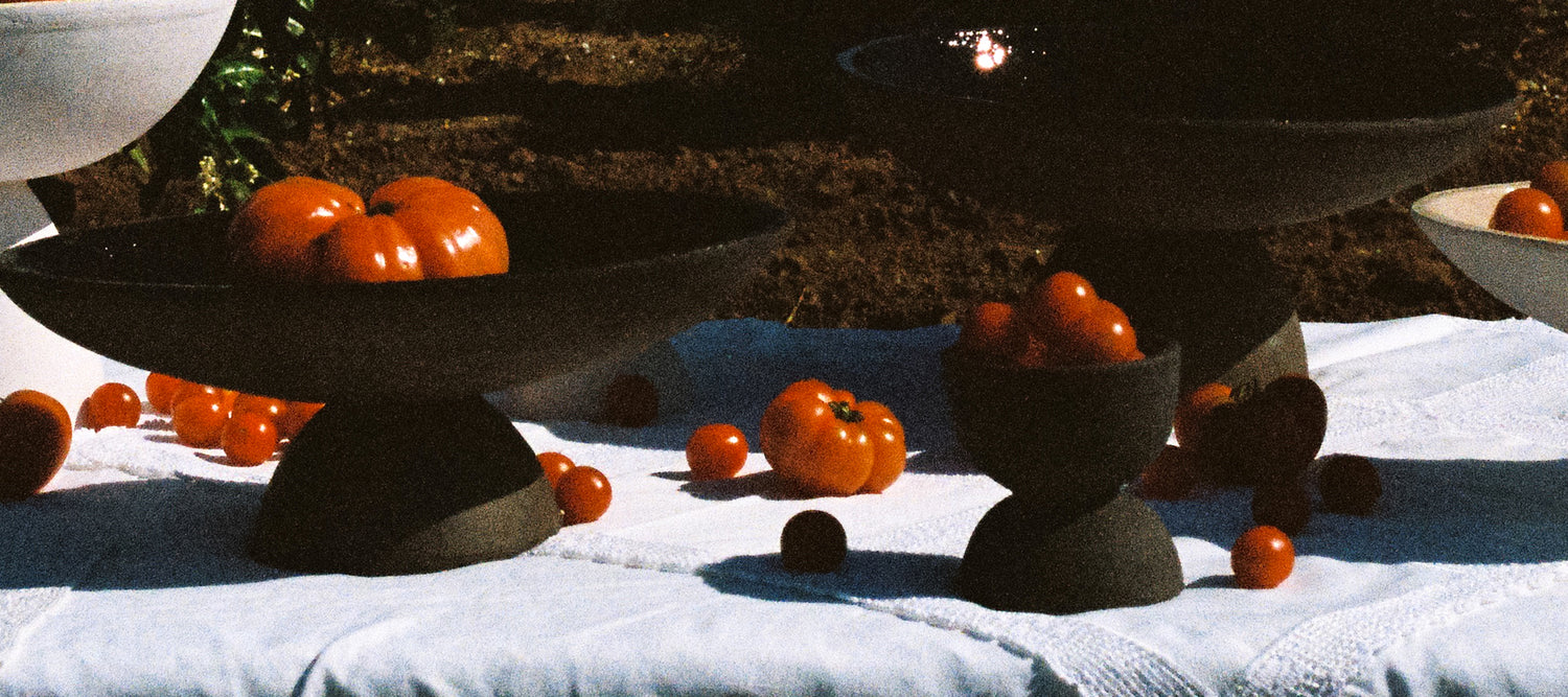Black vases and tomatoes