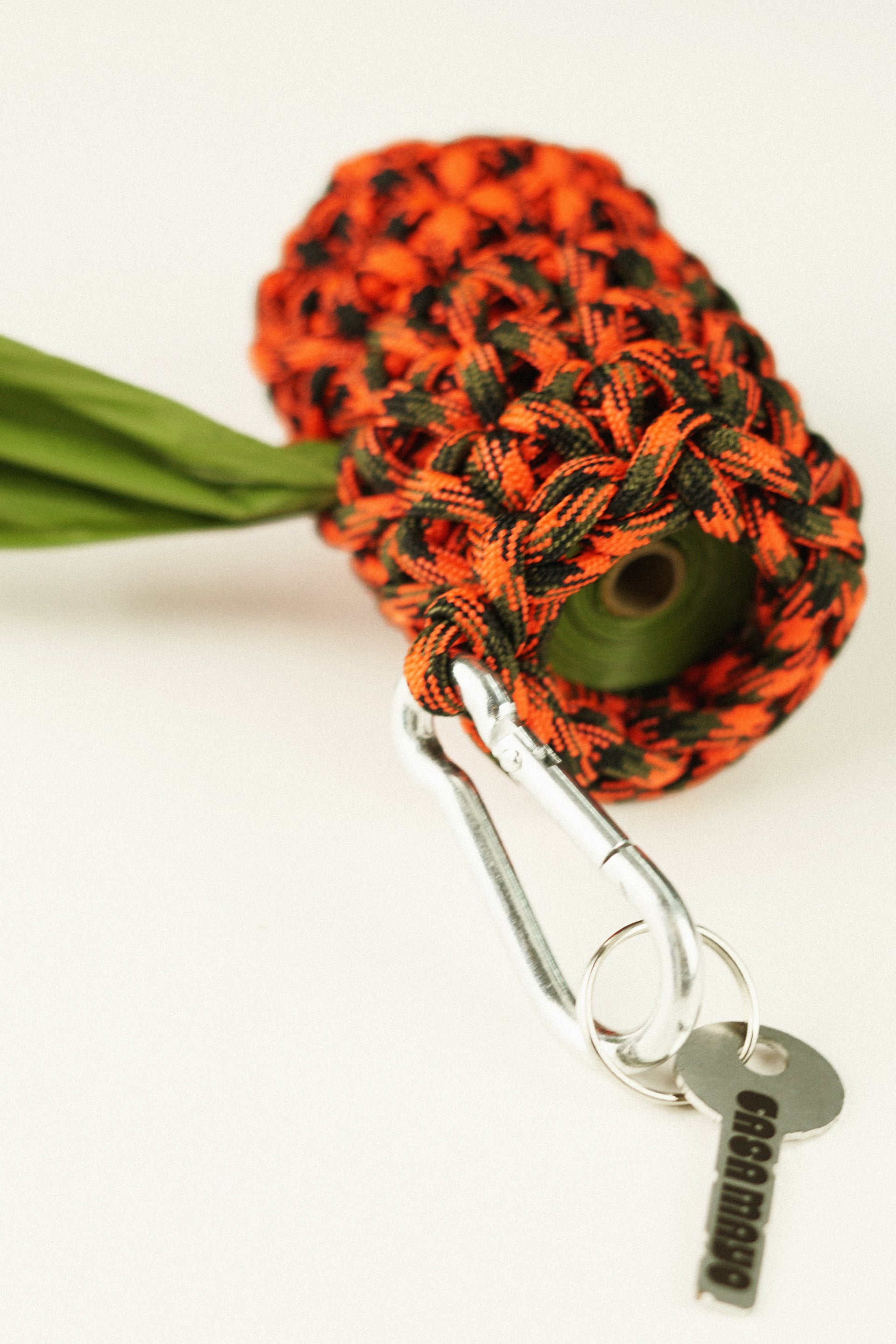 Orange and green pet bag holder made of paracord rope
