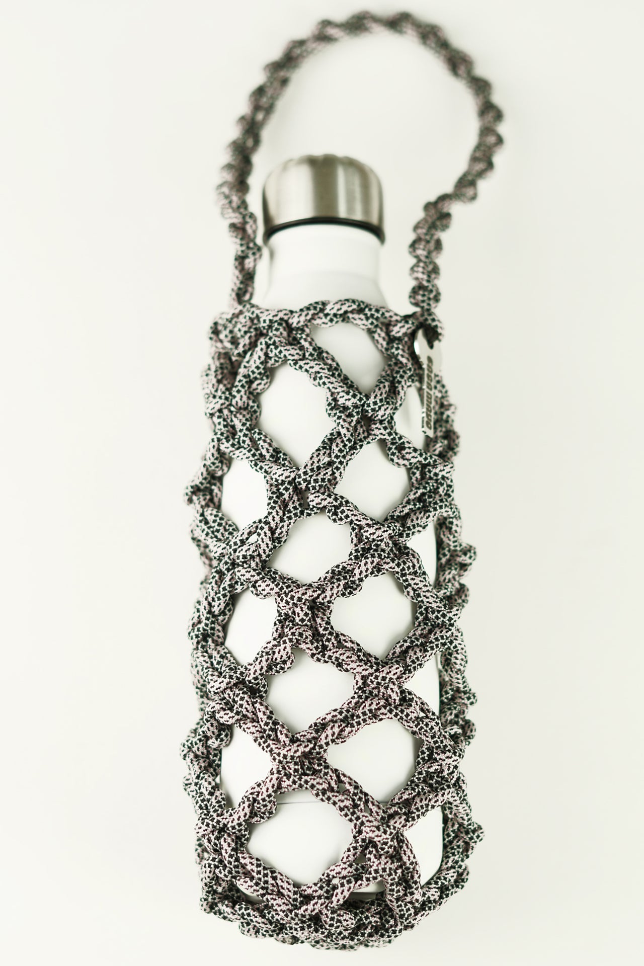 Black and white bottle porter made of paracord rope